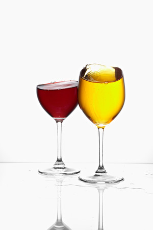 glasses with yellow and red color drink の写真素材