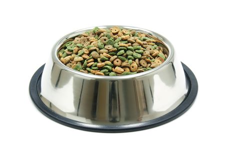 dry pet food in a metal bowl isolated on a white backgroundの写真素材