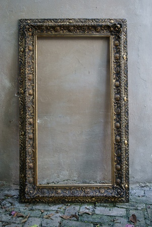 old decorative rectangular picture frame leaning against the wallの写真素材
