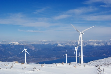 View of the windmills for electricity production on a snowy mountain