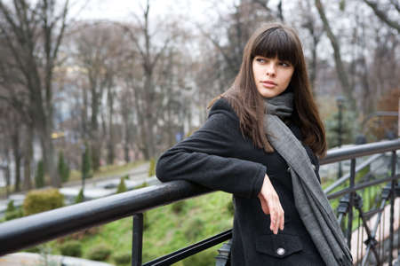 spring, young woman stay lean on the bridge railingの写真素材