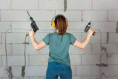 A young woman with drills.の写真素材