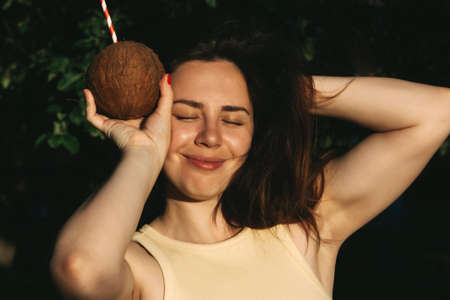 Portrait of a woman with coconutの写真素材