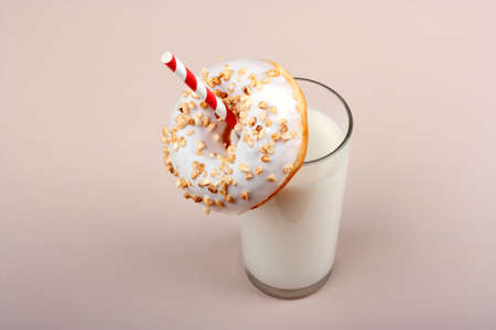 Donut and glass of milk on pink backgroundの写真素材