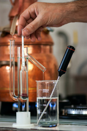 The process of making a strong alcoholic beverage at home. Copper alembic.の写真素材