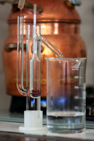 The process of making a strong alcoholic beverage at home. Copper alembic.の写真素材
