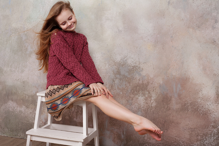 Little girl fooling in the studio, hamming, posing, having fun, enjoying life, carefree childhoodの写真素材
