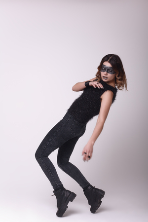beautiful girl posing in the studio, wearing a crown and mask of sequinsの写真素材