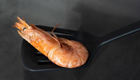 Fine selection of jumbo shrimps for dinner on stone plate.の写真素材