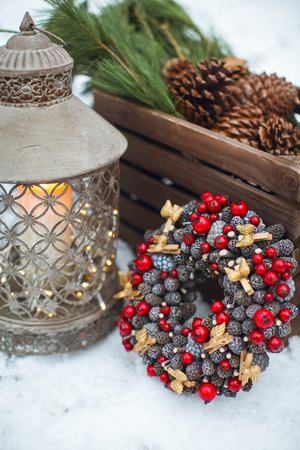 Christmas decoration. Vintage lantern with candles inside. standing in the snow.の写真素材