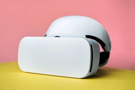 White virtual glasses on a yellow and pink background. Future technologies