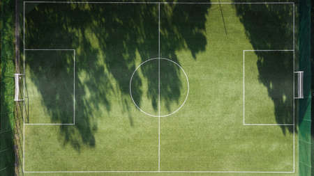 Green soccer field with white lines for the ball game. A shot from above with a drone. Team sport. Top viewの写真素材