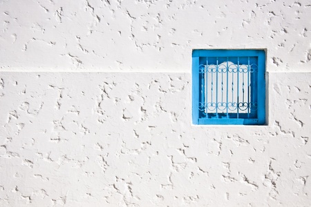 Typical mediterranean small, square, vintage blue windowの写真素材