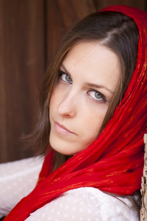 Young attractive woman portraited siting infront of the wooden doors.の写真素材