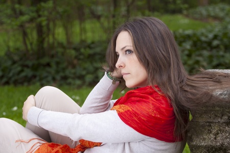 Young attractive woman portraited in the greenery of the city park.の写真素材