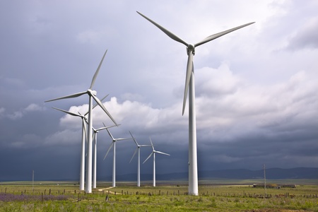 Wind turbines generating electricity in a stormy weather.の写真素材