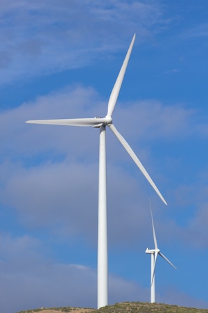 Wind turbine generating electricity with a nice white cloud on the skyの写真素材