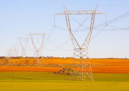 High tension transmission lines crossing the colorful fields of Spain の写真素材