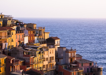 Colourful house frontings glowing in the warm evening sunlight. Cinque Terre - Italy.の写真素材