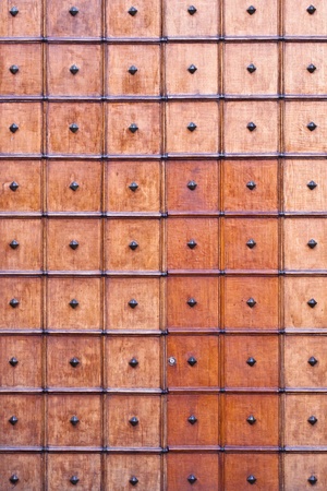 Repeated square pattern on an old wooden church door の写真素材
