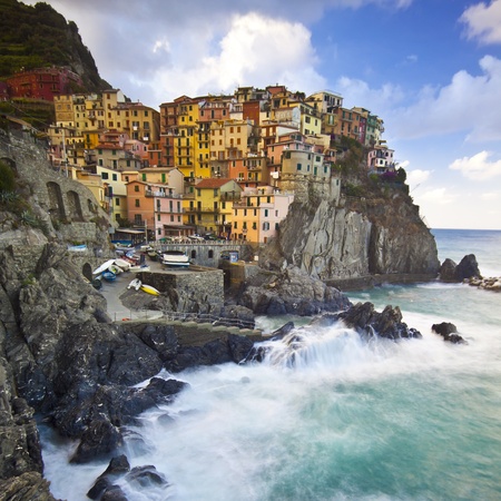 Manarola fisherman village in a dramatic windy weather. Manarola is one of five famous colorful villages of Cinque Terre (Nationa park) in Italy, suspended between sea and land on sheer cliffs upon the wild waves.の写真素材