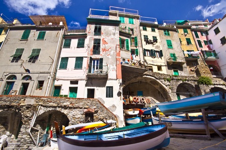 Riomaggiore fisherman village in a dramatic windy weather  Riomaggiore is one of five famous colorful villages of Cinque Terre in Italy, suspended between sea and land on sheer cliffs upon the  turquoise sea のeditorial素材