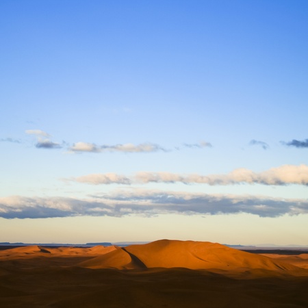 Warm morning light over never ending sand dunes in Morocco.の写真素材