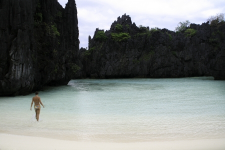 Woman enjoying sunny day on a tropical beach.の写真素材