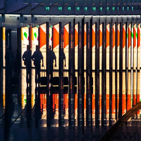 Reflextions of the man with the suitcase on the airpor hall の写真素材