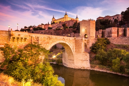 Panorama of the alcazar above the medieval San Martin bridge - Toledo, Spainの写真素材