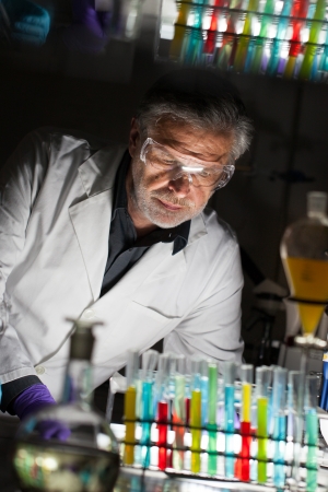 Senior male chemist working late hours in science research laboratory  chemistry, analytical, organic, structural, biochemistry, genetics, forensics, microbiology   の写真素材