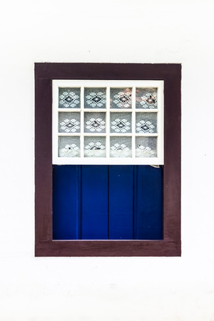 Decorated, vintage, window on a white wall in Paraty (or Parati), Brazil.の写真素材
