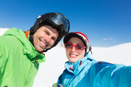 Selfie of couple skiers on winter vacations in the Alp mountains, Triglav natural park, Vogel,...