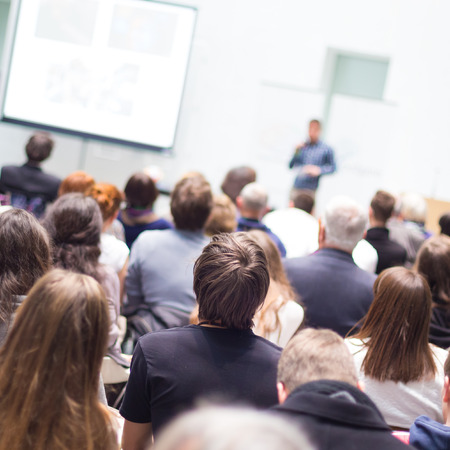 Speaker Giving a Talk at Business Meeting. Audience in the conference hall. Business and Entrepreneurship. Copy space on white board.の写真素材