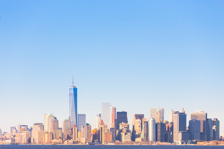 New York City Manhattan downtown skyline at sunset with skyscrapers illuminated over Hudson River...