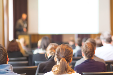 Speaker at Business Conference and Presentation. Audience in the conference hall. Business and Entrepreneurship. Copy space on white screen.の写真素材
