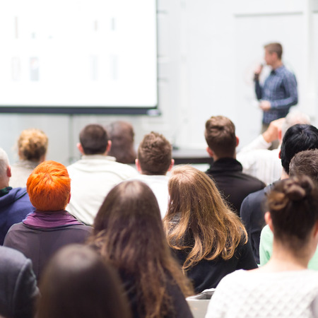 Speaker Giving a Talk at Business Meeting. Audience in the conference hall. Business and Entrepreneurship. Copy space on white board.の写真素材