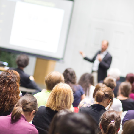 Speaker Giving a Talk at Business Meeting. Audience in the conference hall. Business and Entrepreneurship. Copy space on white board.の写真素材