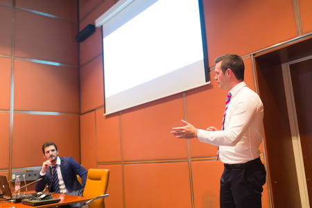Speaker giving talk on podium at Business Conference. Entrepreneurship club. Horisontal composition.の写真素材