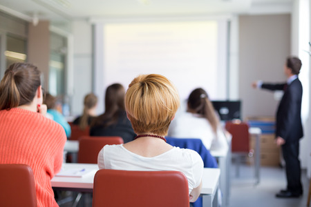 Speaker Giving a Talk at Business Meeting. Audience in the conference hall. Business and Entrepreneurship. Copy space on white board.の写真素材