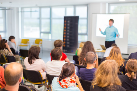 Speakers Giving a Talk at Business Meeting. Audience in the conference hall. Business and...