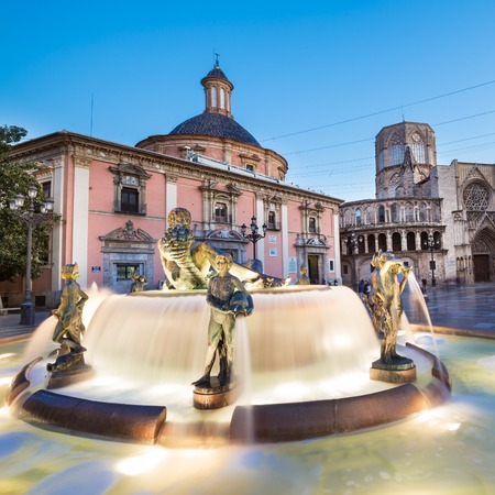 Square of Saint Mary's, fountain Rio Turia and cathedral in background at dusk in Valencia, Spain.の写真素材