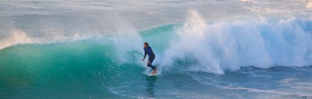 La Pared, Spain - Dec 23, 2015:  Active sporty senior surfer riding perfect wave on La Pared beach, famous surfing destination on Fuerteventura, Canary Islands, Spain on December 23, 2015.のeditorial素材