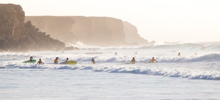 EL Cotillo, Spain - Dec 17, 2015:  Active sporty people having fun learning to surf on El Cotillo beach, famous surfing destination on Fuerteventura, Canary Islands, Spain on December 17, 2015.のeditorial素材