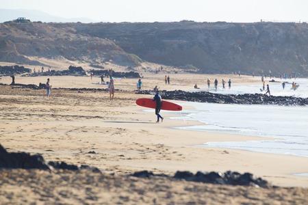 EL Cotillo, Spain - Dec 17, 2015:  Active sporty people having fun learning to surf on El Cotillo beach, famous surfing destination on Fuerteventura, Canary Islands, Spain on December 17, 2015.のeditorial素材