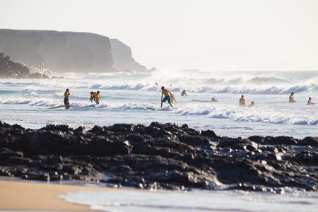 EL Cotillo, Spain - Dec 17, 2015:  Active sporty people having fun learning to surf on El Cotillo beach, famous surfing destination on Fuerteventura, Canary Islands, Spain on December 17, 2015.のeditorial素材