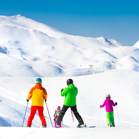 Family on winter ski vacations in ski slopes in Alps, Vogel, Slovenia, Europe.の写真素材