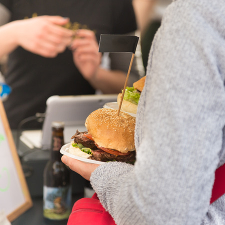 Beef burgers being served on food stall on open kitchen international food festival event of street food.の写真素材