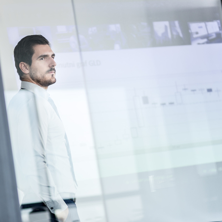 Business man making a presentation in front of whiteboard. Business executive delivering a...