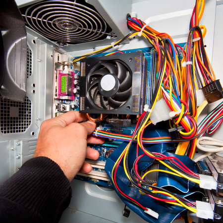 Interior of the personal computer. Power suplay motherboard, cables, discs, fan